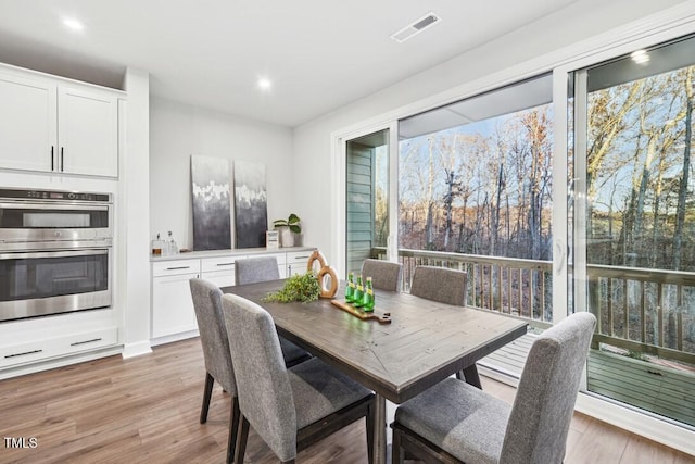 dining room featuring a healthy amount of sunlight and light wood-type flooring