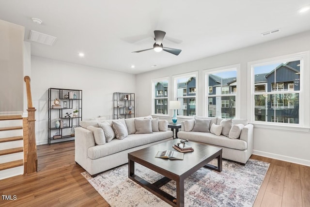 living room with ceiling fan and hardwood / wood-style flooring