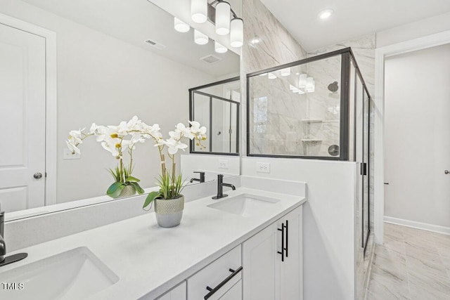 bathroom featuring vanity and a shower with door