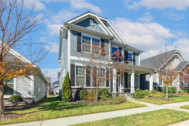 view of front of house featuring covered porch and a front yard