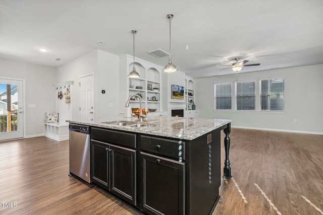 kitchen with dishwasher, dark hardwood / wood-style flooring, a kitchen island with sink, and sink