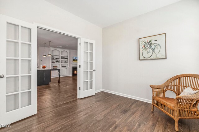 living area with dark wood-type flooring and french doors