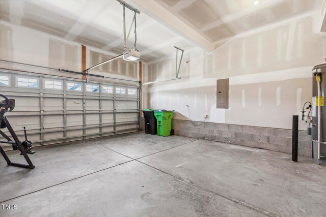 garage with electric panel, a garage door opener, and water heater