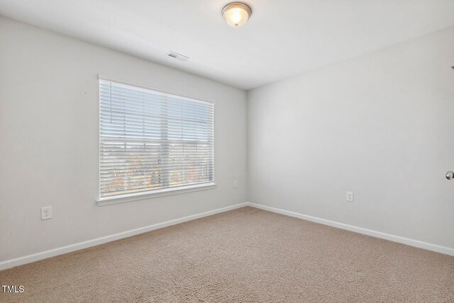 unfurnished room featuring carpet flooring