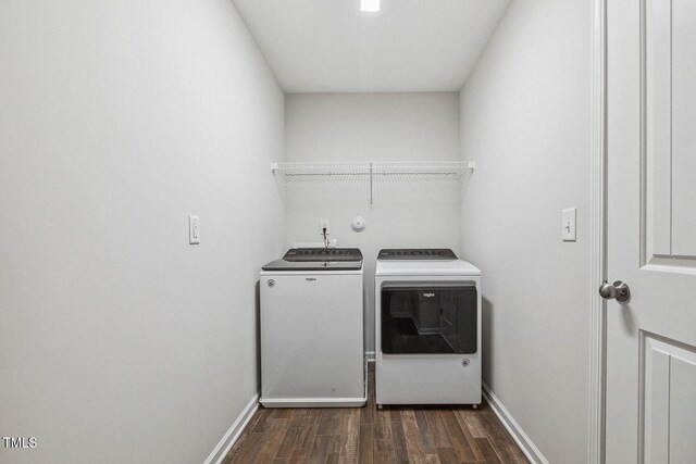 laundry area with washer and clothes dryer and dark wood-type flooring