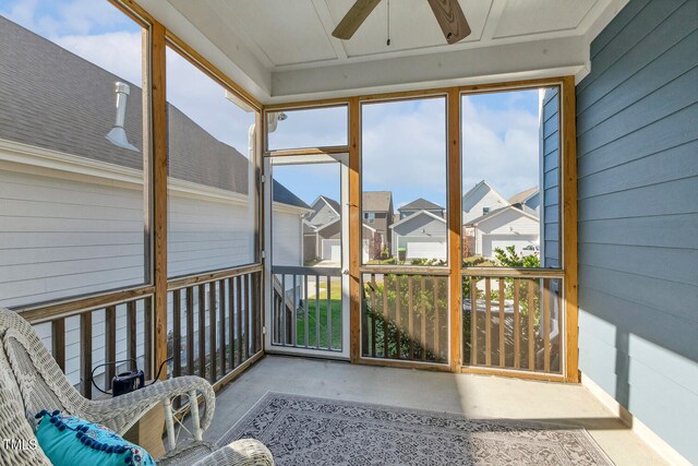 unfurnished sunroom featuring ceiling fan