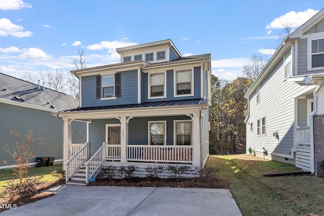 view of front of home with covered porch and a front yard