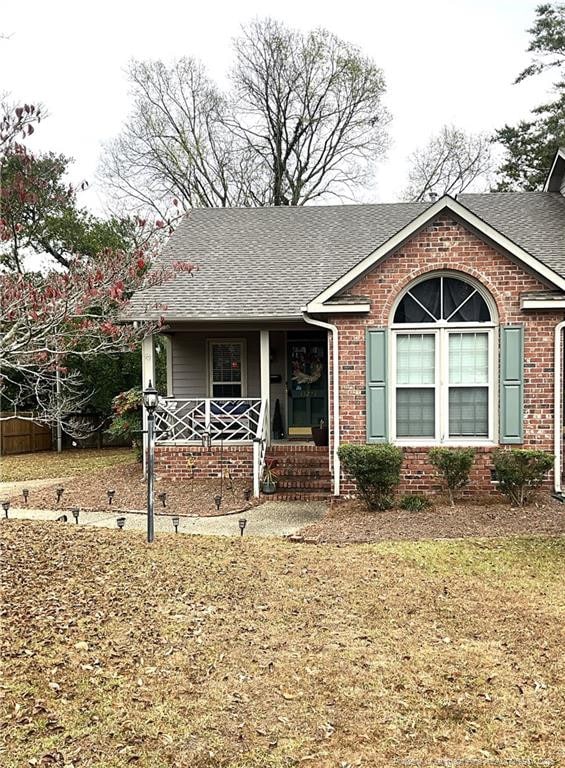 view of front of home with covered porch and a front yard