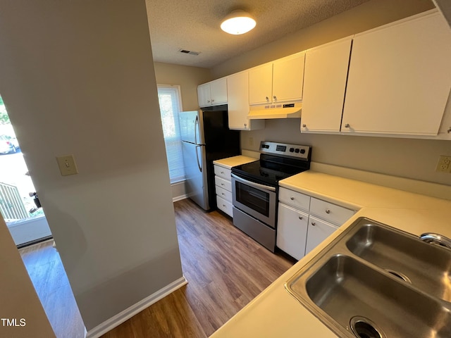 kitchen featuring white cabinetry, appliances with stainless steel finishes, a textured ceiling, sink, and hardwood / wood-style flooring