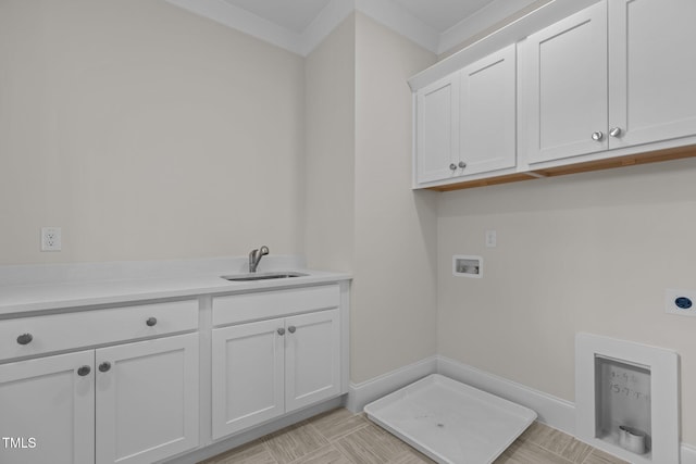 washroom with ornamental molding, hookup for a washing machine, cabinets, sink, and electric dryer hookup