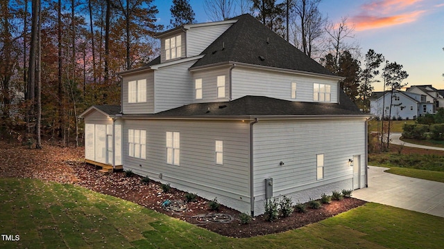 2105 Gentry Rd, Wake Forest, NC 27587 - property exterior at dusk with roof with shingles, a yard, and a patio