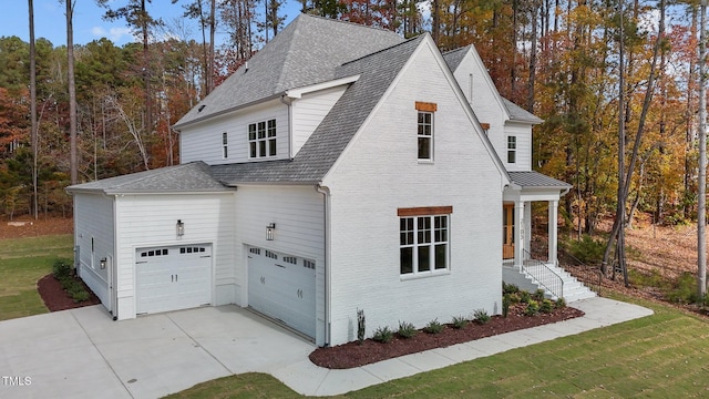 view of home's exterior featuring a garage and a lawn