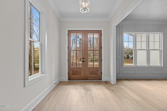 2105 Gentry Rd, Wake Forest, NC 27587 - doorway featuring healthy amount of natural light, light wood-style flooring, french doors, baseboards, and crown molding