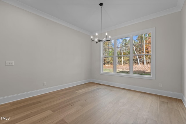 unfurnished dining area with ornamental molding, light hardwood / wood-style flooring, and an inviting chandelier