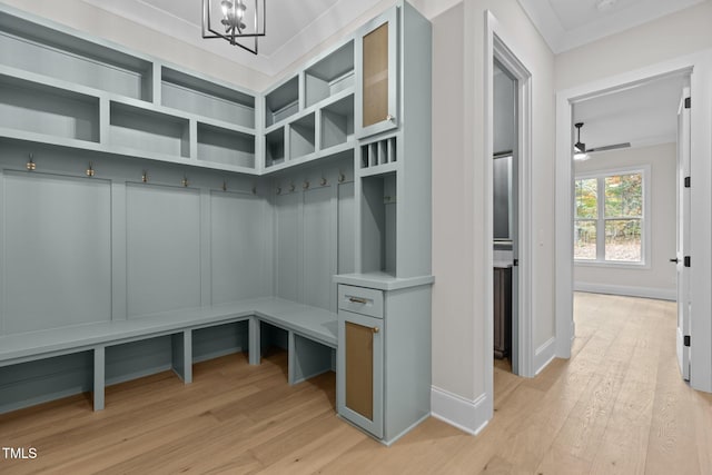 mudroom featuring ceiling fan with notable chandelier, light hardwood / wood-style floors, and crown molding