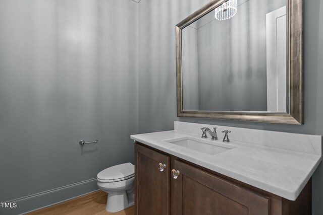 2105 Gentry Rd, Wake Forest, NC 27587 - bathroom featuring wood finished floors, toilet, vanity, and baseboards