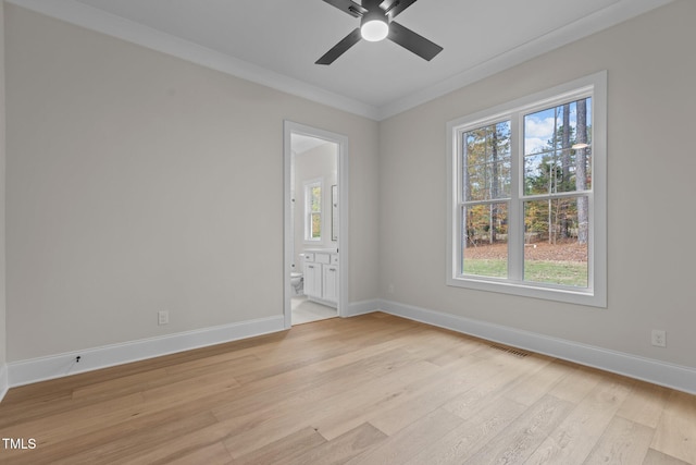 spare room featuring light hardwood / wood-style floors, ceiling fan, and crown molding