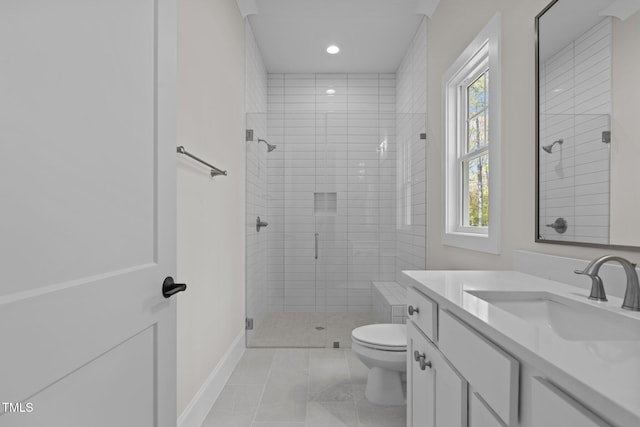 bathroom featuring vanity, a healthy amount of sunlight, toilet, and a shower with shower door