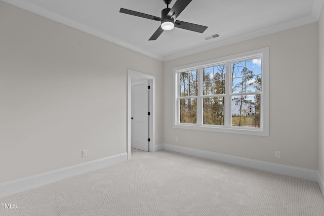 carpeted empty room featuring ceiling fan and crown molding