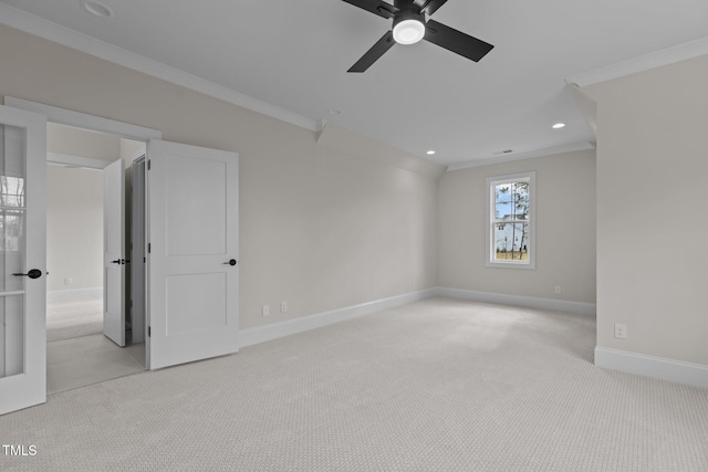 carpeted spare room with ceiling fan and ornamental molding