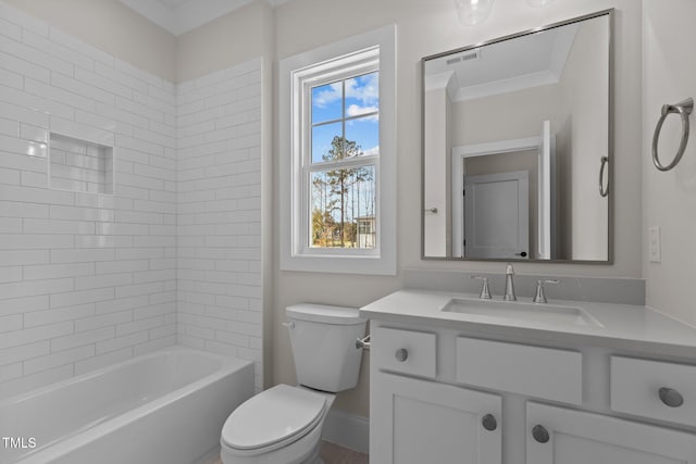 full bathroom featuring toilet, tiled shower / bath combo, vanity, and ornamental molding