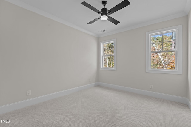 carpeted empty room featuring ceiling fan and crown molding