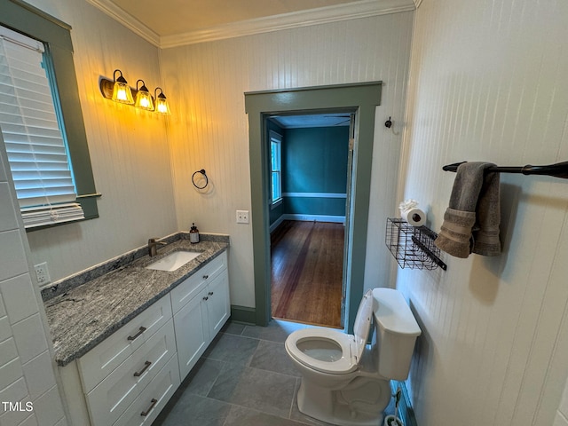 bathroom with hardwood / wood-style flooring, vanity, toilet, and crown molding