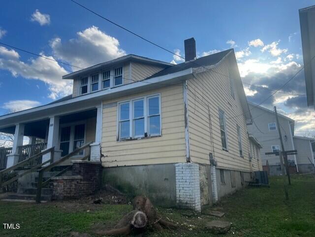 view of side of property with a porch