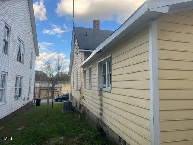 view of side of home with central air condition unit