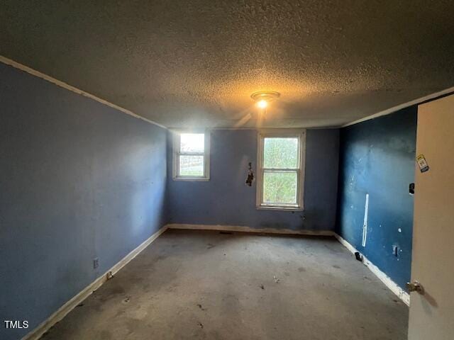 unfurnished room featuring a textured ceiling and concrete floors