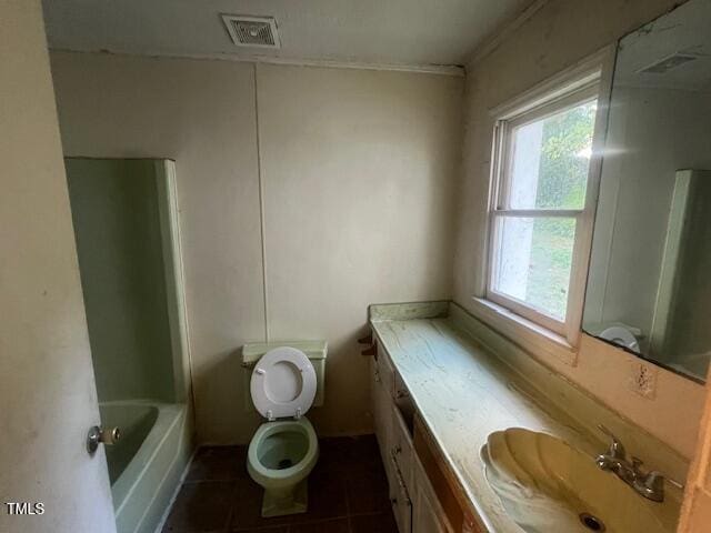 bathroom with a tub, tile patterned flooring, vanity, and toilet