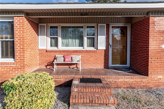 view of exterior entry with a porch