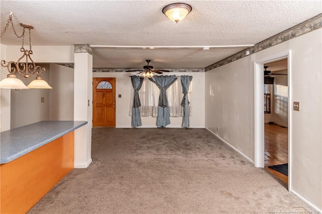 carpeted empty room featuring a textured ceiling and ceiling fan