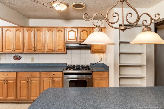 kitchen featuring stainless steel gas stove, a textured ceiling, and decorative backsplash