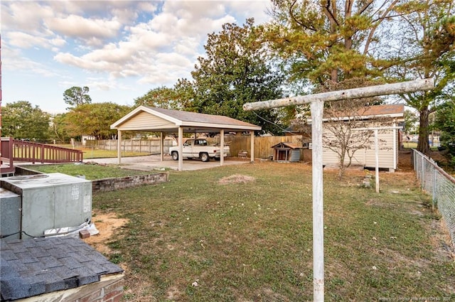 view of yard featuring a storage unit and a carport