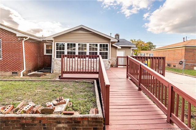 rear view of house with a wooden deck