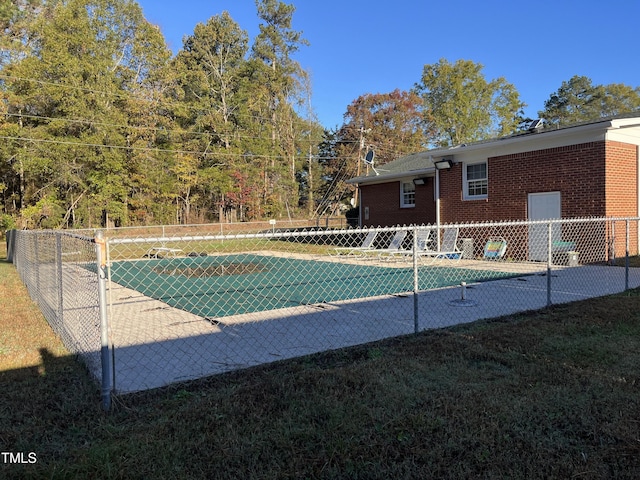 view of pool featuring a lawn, a fenced in pool, and fence