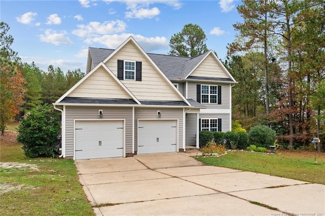 view of front of house featuring a garage and a front lawn