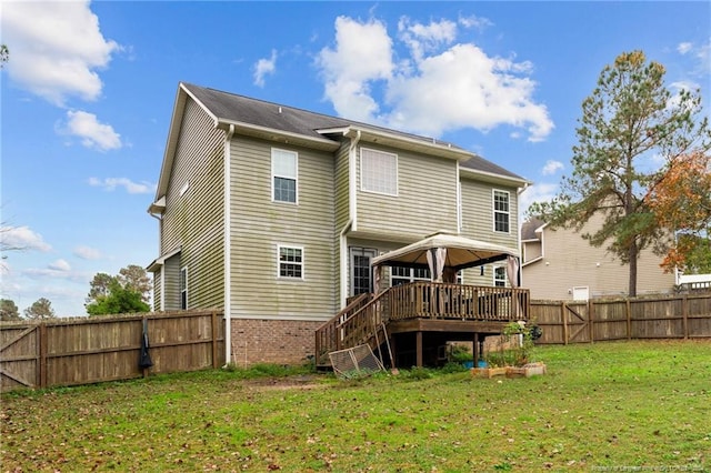 rear view of house featuring a lawn, a gazebo, and a wooden deck