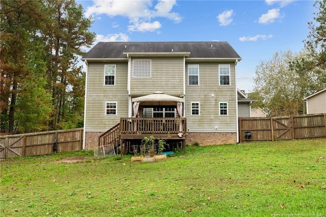 rear view of house with a lawn, a gazebo, and a wooden deck