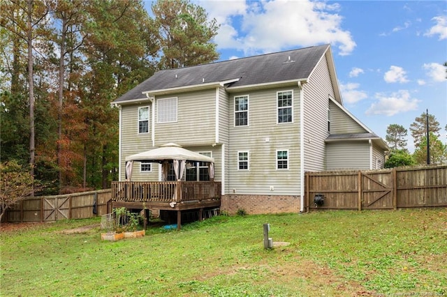 back of house with a deck, a yard, and a gazebo