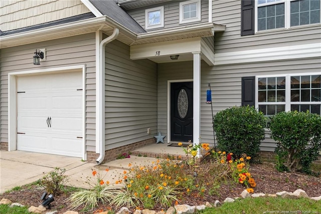 view of exterior entry with a garage