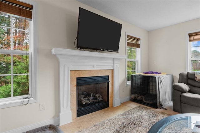 living room featuring light tile patterned flooring and a tile fireplace