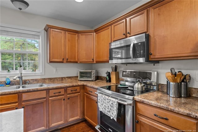 kitchen featuring dark hardwood / wood-style flooring, appliances with stainless steel finishes, and sink