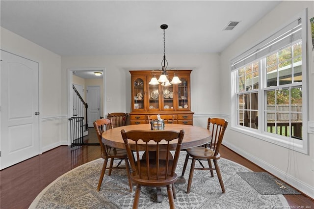 dining space with dark hardwood / wood-style flooring