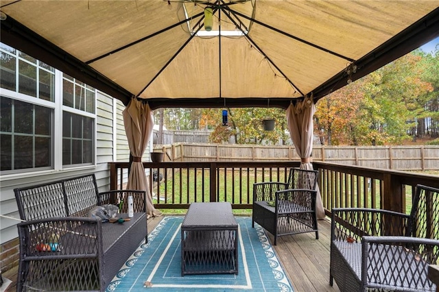 wooden deck with an outdoor hangout area, a yard, and a gazebo