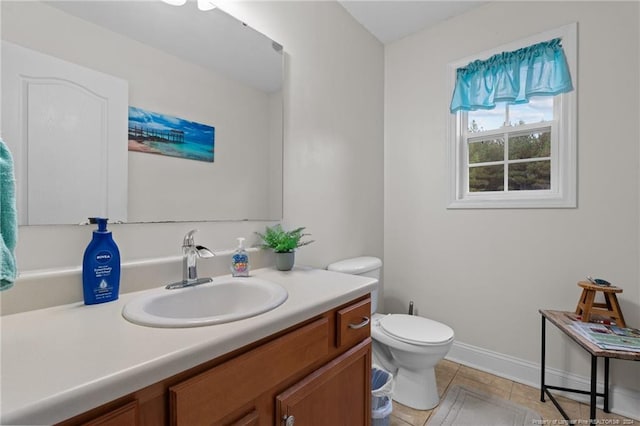 bathroom featuring toilet, vanity, and tile patterned floors