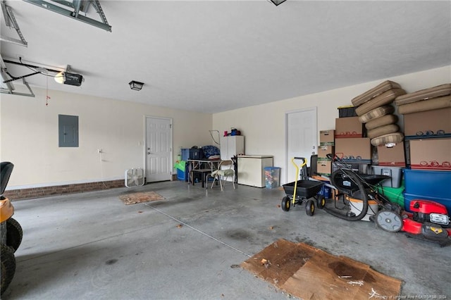 garage with electric panel, a garage door opener, and stainless steel refrigerator