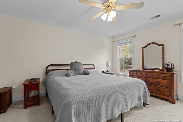 bedroom with ceiling fan, crown molding, and light colored carpet