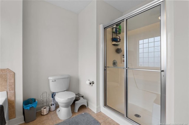 bathroom with walk in shower, tile patterned flooring, and toilet